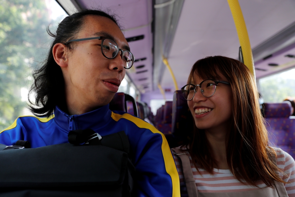 Derek Tai and his girlfriend Ann take a bus to a legal protest in Hong Kong, China, January 19, 2020. Reuters/Tyrone Siu
 