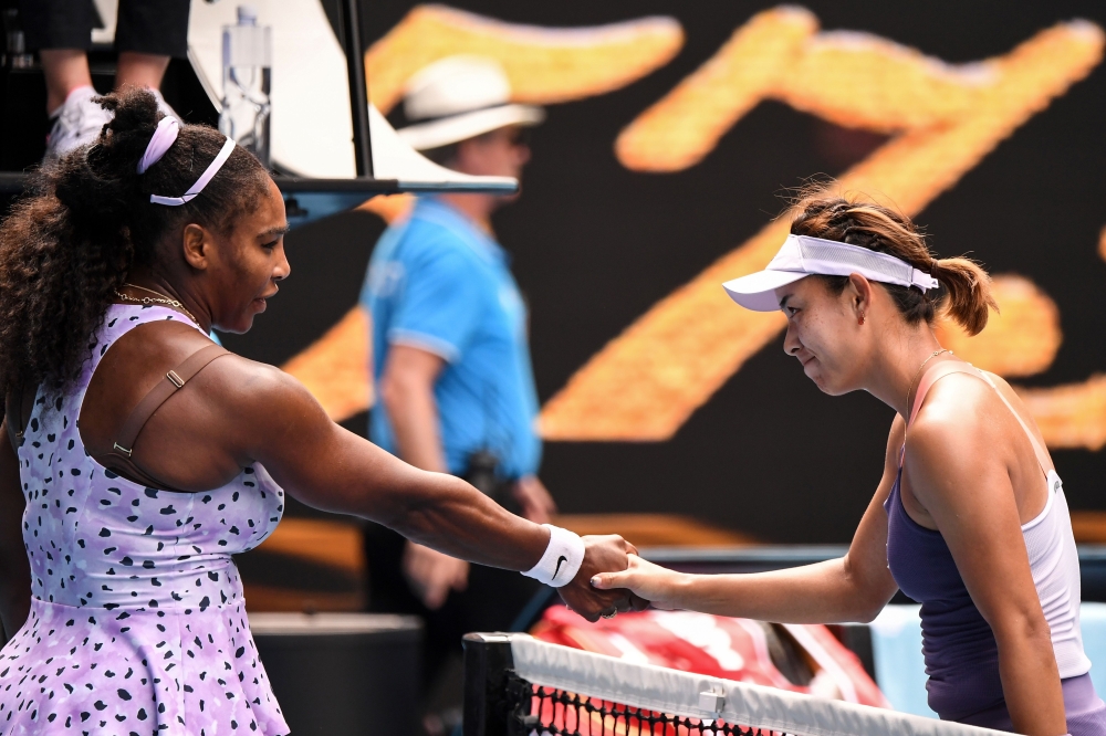 China's Wang Qiang (R) shakes hands with Serena Williams of the US after victory during their women's singles match on day five of the Australian Open tennis tournament in Melbourne on January 24, 2020. IMAGE RESTRICTED TO EDITORIAL USE - STRICTLY NO COMM
