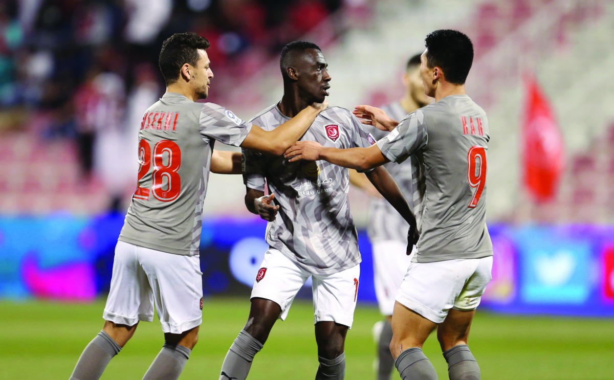 Almoez Ali (centre) celebrates with team-mates after scoring a goal against Al Arabi yesterday.