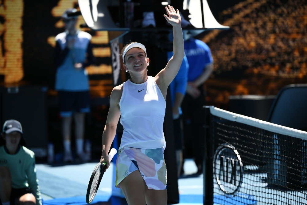 Romania's Simona Halep celebrates after a victory against Kazakhstan's Yulia Putintseva during their women's singles match on day six of the Australian Open tennis tournament in Melbourne on January 25, 2020. AFP / Manan Vatsyayana 