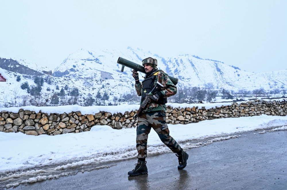 A security personnel walks on a road as he patrols near a site of a gunbattle between suspected militants and government forces at Khrew area of Pampore in Pulwama district, south of Srinagar on January 21, 2020. AFP / Tauseef Mustafa 