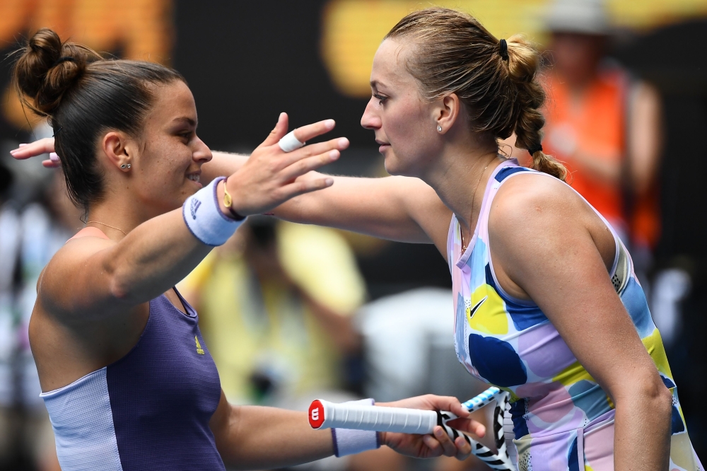 Greece's Maria Sakkari (L) congratulates Czech Republic's Petra Kvitova on her win in their women's singles match on day seven of the Australian Open tennis tournament in Melbourne on January 26, 2020.  AFP / William West 