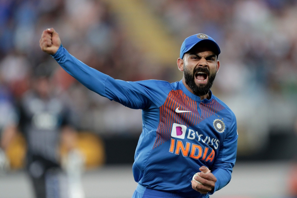 India’s captain Virat Kohli reacts after catching New Zealand’s Martin Guptill during the second Twenty20 cricket match between New Zealand and India at Eden Park in Auckland on January 26, 2020. / AFP / DAVID ROWLAND 