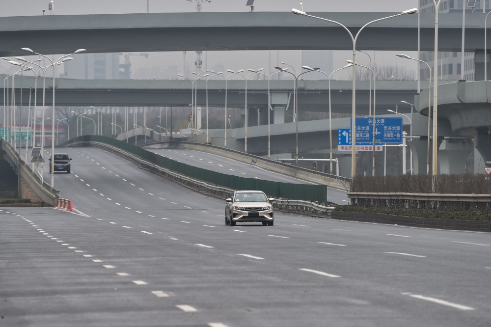 Cars are seen on a road on the first day of the Lunar New Year in Wuhan in China's central Hubei province on January 25, 2020, during a deadly virus outbreak which began in the city. AFP / Hector Retamal 