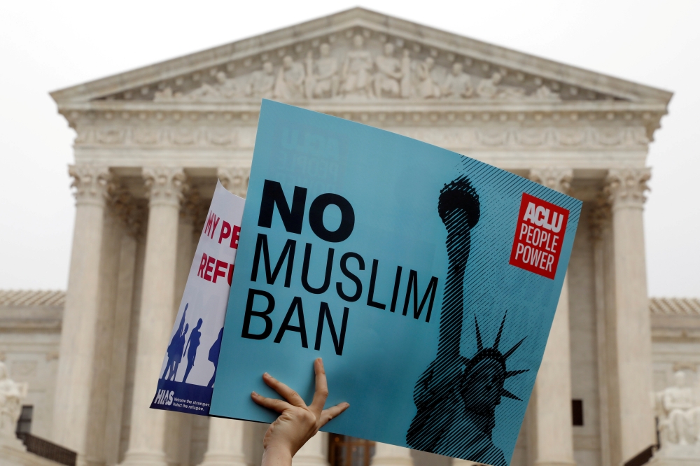 FILE PHOTO: Protesters rally outside the US Supreme Court while it  it weighs the legality of Trumps’ latest travel ban targeting people from Muslim-majority countries. Reuters / Yuri Gripas