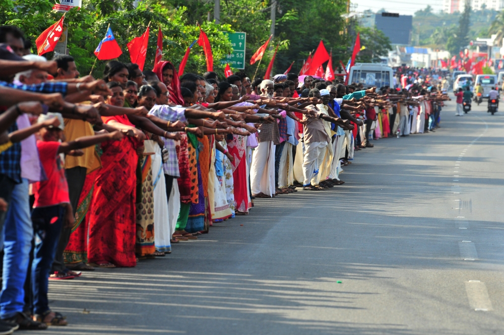 People line up along a road to form a 620 km human chain across the southern state of Kerala organized by the Left Democratic Front (LDF) to protest against the Indian government's Citizenship Amendment Act (CAA), Thiruvananthapuram on January 26, 2020. A