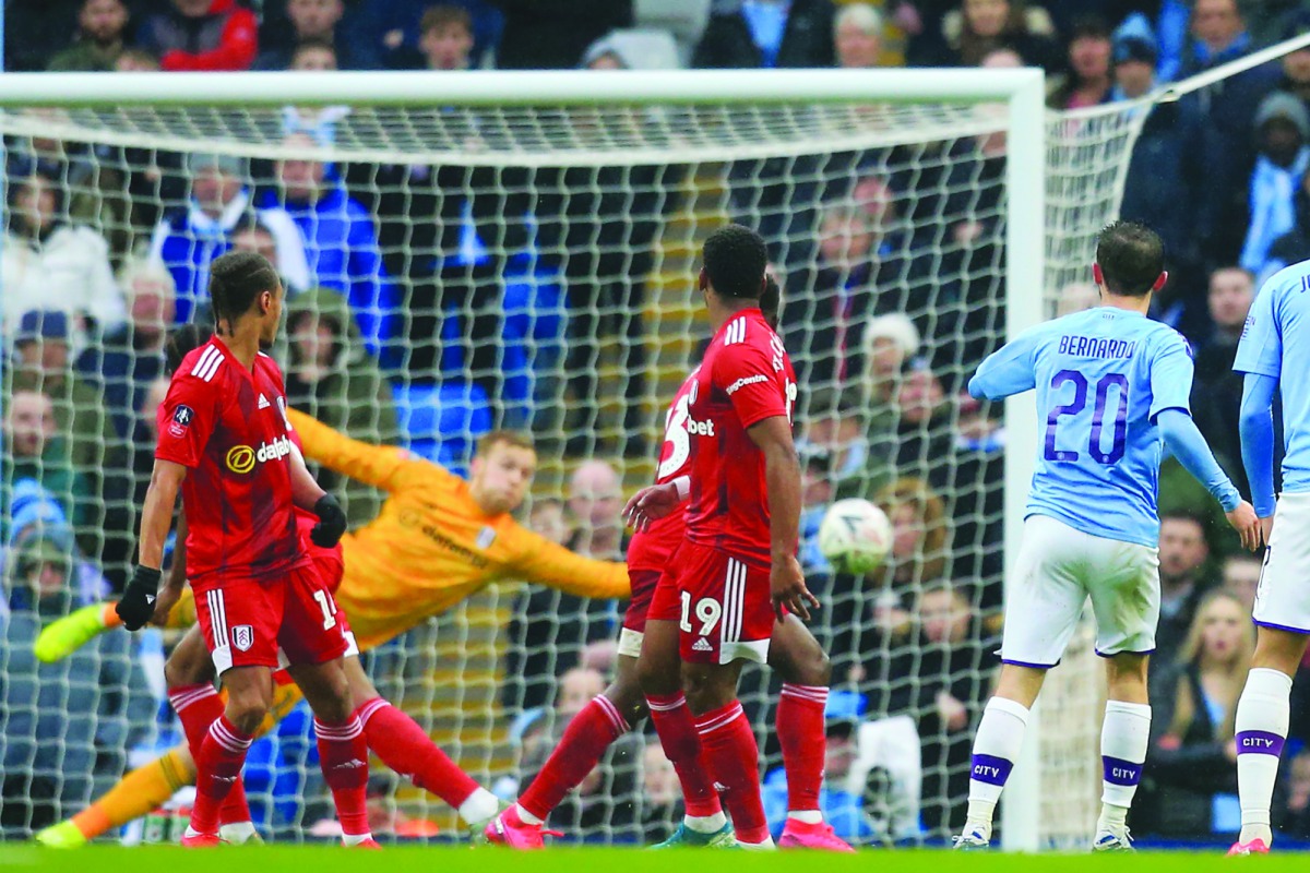 Manchester City midfielder Bernardo Silva (right) shoots to score their second goal during the English FA Cup fourth round match against Fulham at the Etihad Stadium in Manchester, northwest England, yesterday.