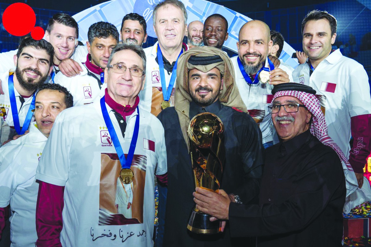 The President of Qatar Olympic Committee H E Sheikh Joaan bin Hamad Al Thani and Qatar Handball Association President Ahmed Mohammed Al Shaabi and coach Valero Rivera Lopez pose for a picture with the victorious Qatar team, winners of the 19th Asian Handb