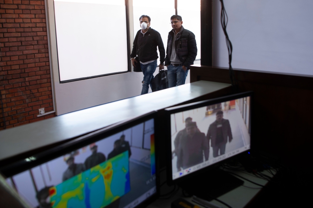 Passengers are seen on the screen of a thermal scanner as they arrive at the Tribhuvan International Airport after Nepal confirmed the first case of coronavirus in the country, in Kathmandu on January 29, 2020, following the first SARS-like virus confirme