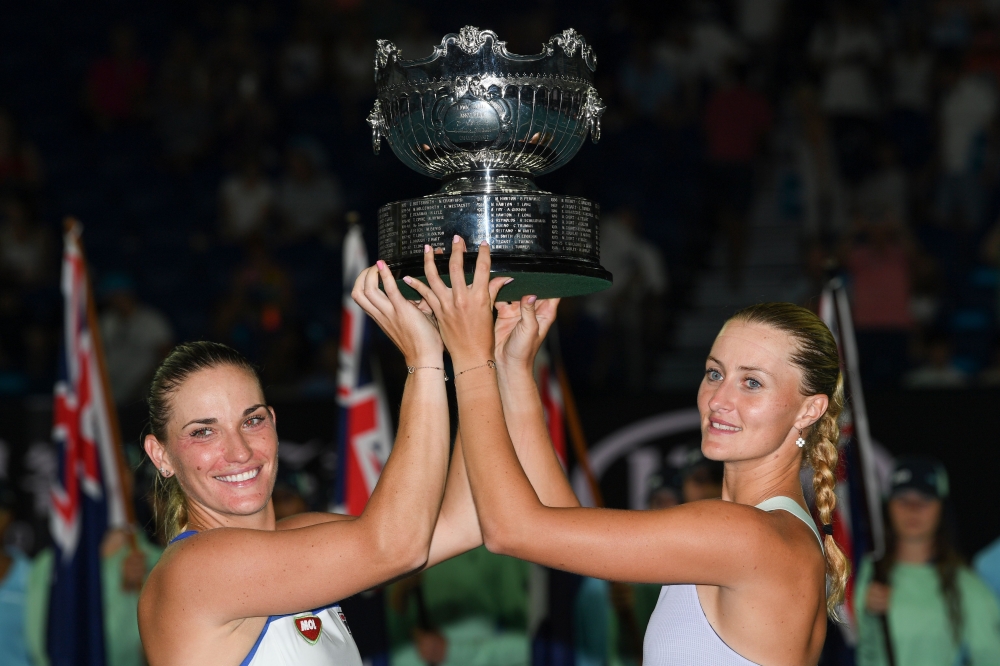 Hungary's Timea Babos (L) and France's Kristina Mladenovic (R) pose with the championship trophy during the awards ceremony after their victory against Taiwan's Hsieh Su-wei and Czech Republic's Barbora Strycova during the women's doubles final on day twe