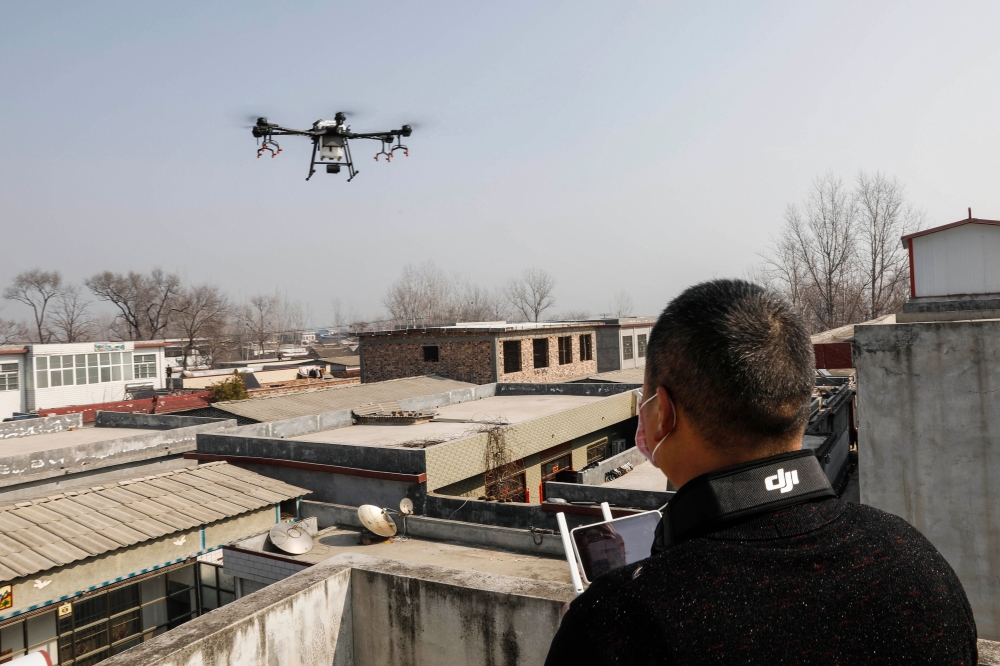 A representational image of a local resident using a drone to spray disinfectant at a village in Pingdingshan, in China's central Henan province on January 31, 2020, during the virus outbreak in Hubei's city of Wuhan. China OUT / AFP / STR