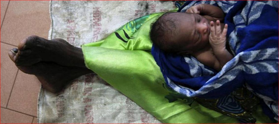 In this 2007 photo a woman holds her newborn grandson as she sits on the floor of maternity ward of Lacor hospital in northern Uganda. Reuters / Euan Denholm