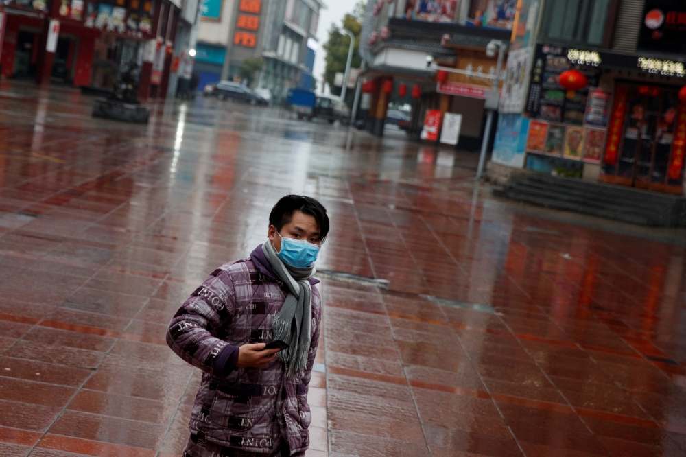 A man wearing a face mask walks in a deserted shopping area in Jiujiang, Jiangxi province, China, as the country is hit by an outbreak of the novel coronavirus, February 2, 2020. Reuters / Thomas Peter