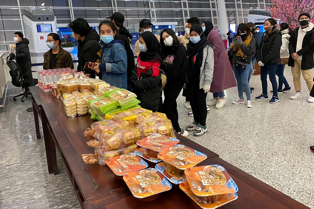 Indonesian citizens wait to be evacuated, ahead of departure to Indonesia at Tianhe International Airport, in Wuhan, Hubei, China February 1, 2020 in this photo taken by Antara Foto. Picture taken by February 1, 2020. Antara Foto/ via REUTERS 