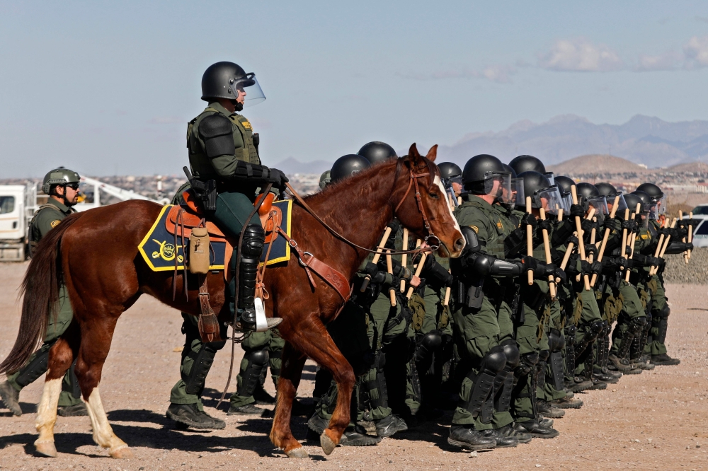 US Border Patrol agents conduct a training exercise in the Anapra area, in front of the wall that divides Sunland Park, New Mexico, US, from Mexico, as seen from Ciudad Juarez, Chihuahua state, on January 31, 2020. AFP / Herika Martinez 
 