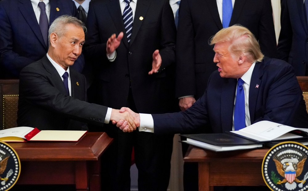 File photo: Chinese Vice Premier Liu He and US President Donald Trump after signing phase one of the US-China trade agreement in the White House, January 15, 2020. Reuters / Kevin Lamarque 
 
