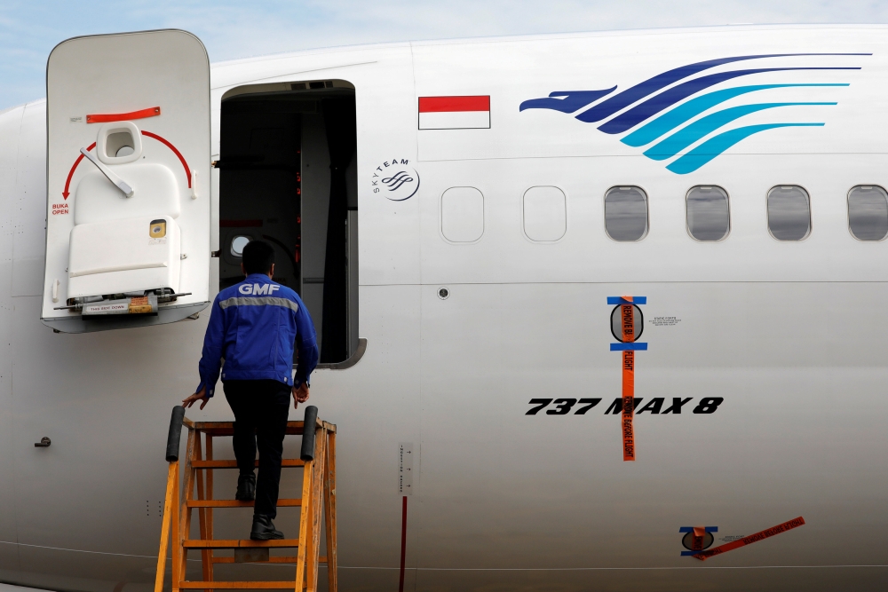 A technician prepares to check Boeing 737 Max 8 airplane of Garuda Indonesia parked at the Garuda Maintenance Facility AeroAsia at Soekarno-Hatta International airport, March 13, 2019. Reuters / Willy Kurniawan