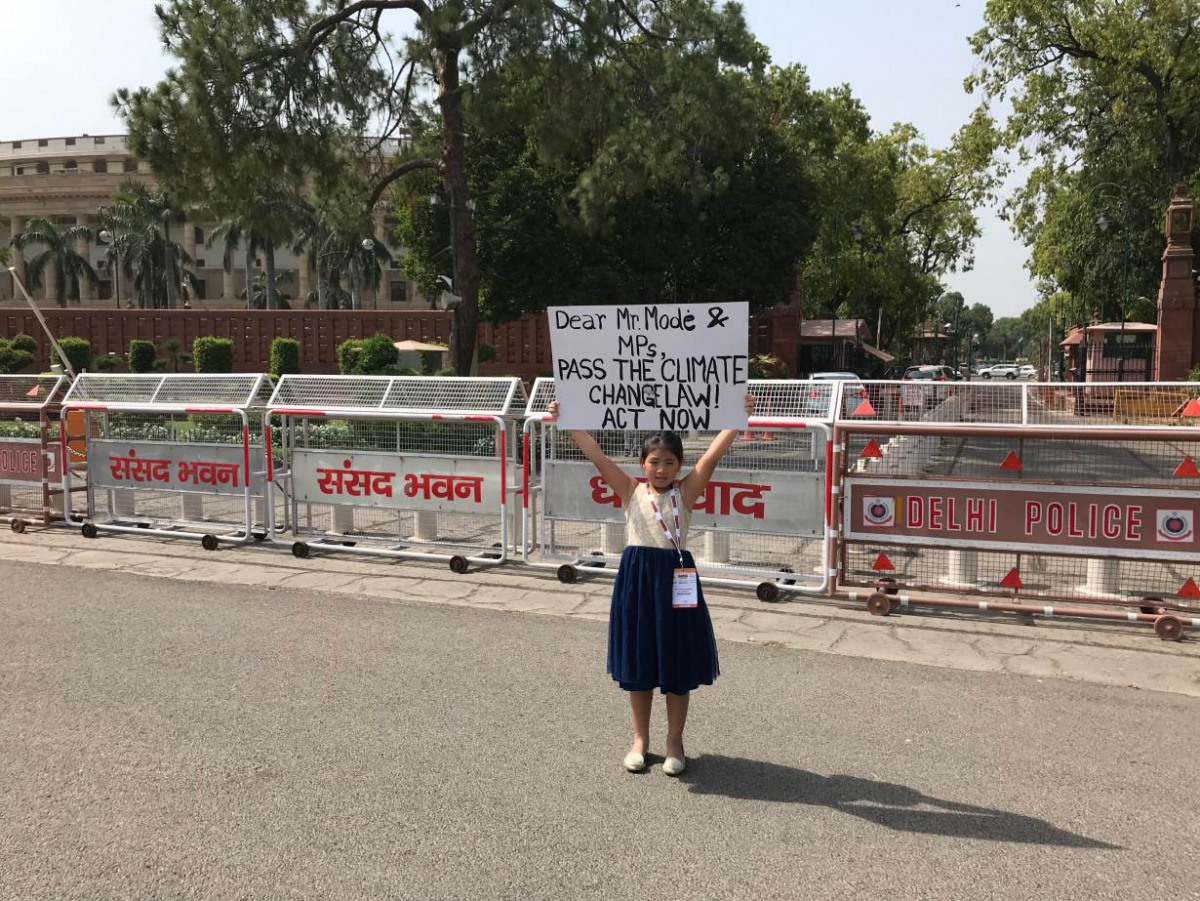 Youth climate activist, Licypriya Kangujam, holds up a poster to demand a law on climate change outside the federal parliament in New Delhi, India on February 2, 2019. The Child Movement handout