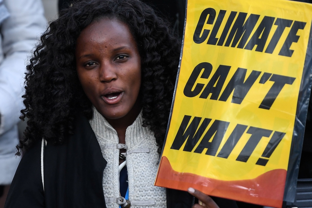 A demonstrator holds a placard during a protest on climate emergency called by environmental groups outside the UN Climate Change Conference COP25 in Madrid on December 13, 2019. AFP / Pierre-Philippe Marcou 