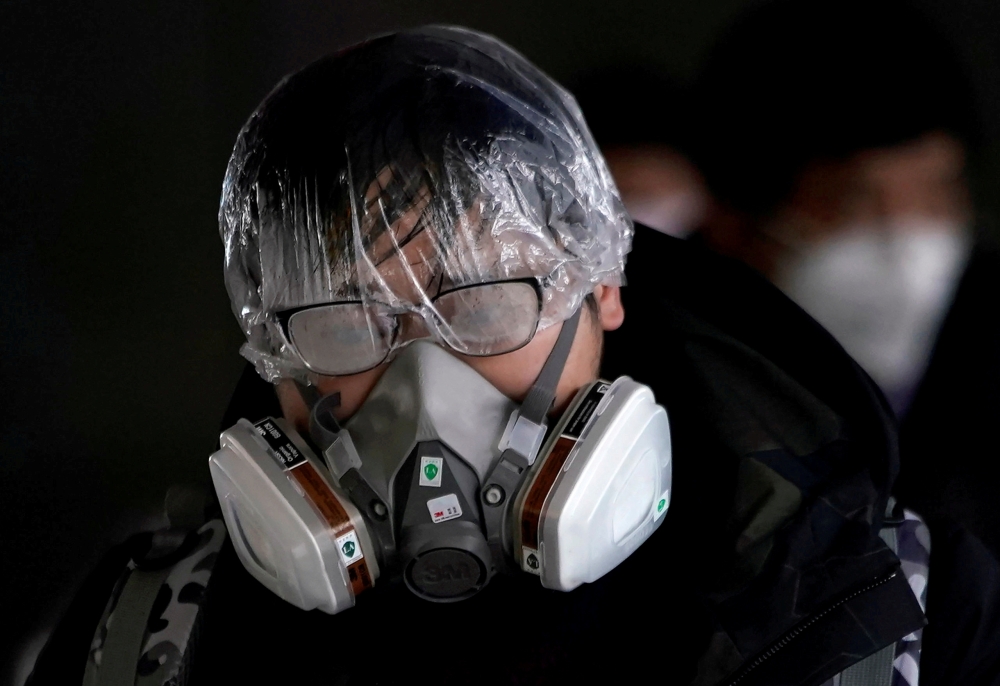 A passenger wearing a mask walks outside the Shanghai railway station in Shanghai, China, as the country is hit by an outbreak of the novel coronavirus, February 8, 2020. REUTERS/Aly Song 