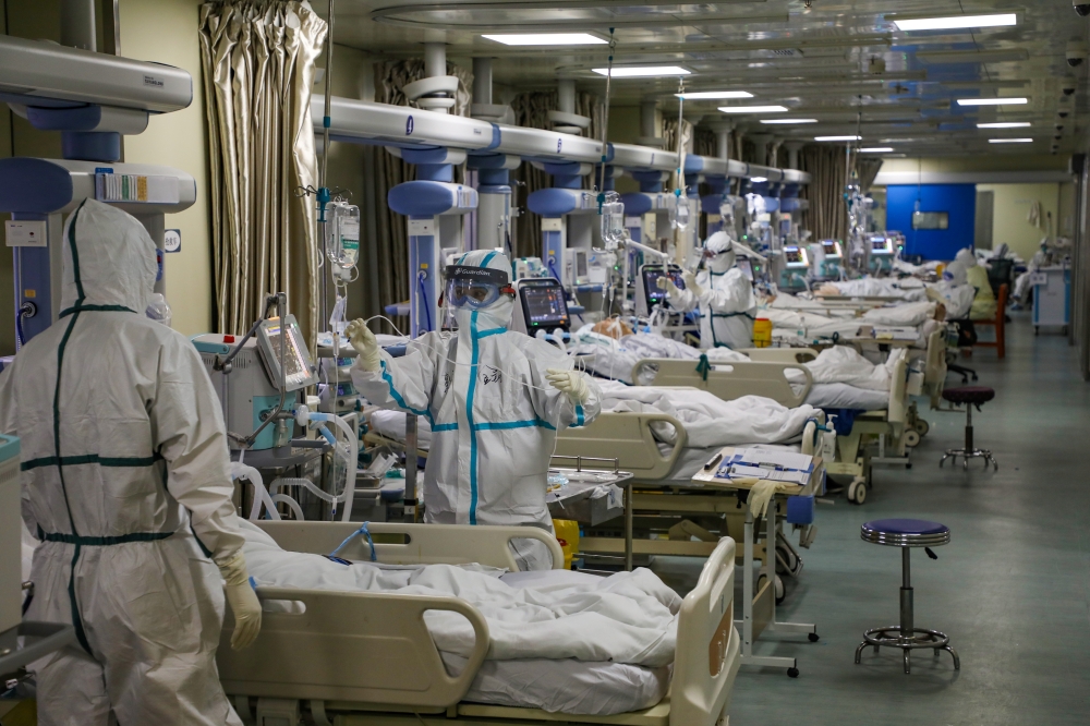 Medical workers in protective suits attend to novel coronavirus patients at the intensive care unit (ICU) of a designated hospital in Wuhan, Hubei province, China February 6, 2020. Picture taken February 6, 2020.