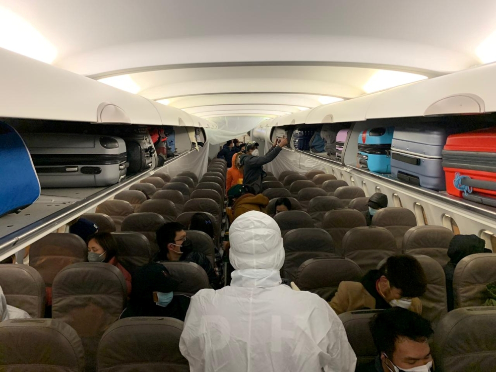 Filipinos, voluntarily evacuated due to the coronavirus outbreak, board a plane from Wuhan, Hubei, China, February 9, 2020. Courtesy of Department of Foreign Affairs/Handout via REUTERS 