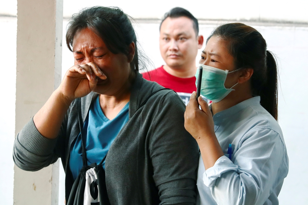 Victim's family members cry at a hospital following a gun battle involving a Thai soldier on a shooting rampage, in Nakhon Ratchasima, Thailand, February 9, 2020. Reuters/Athit Perawongmetha
 
