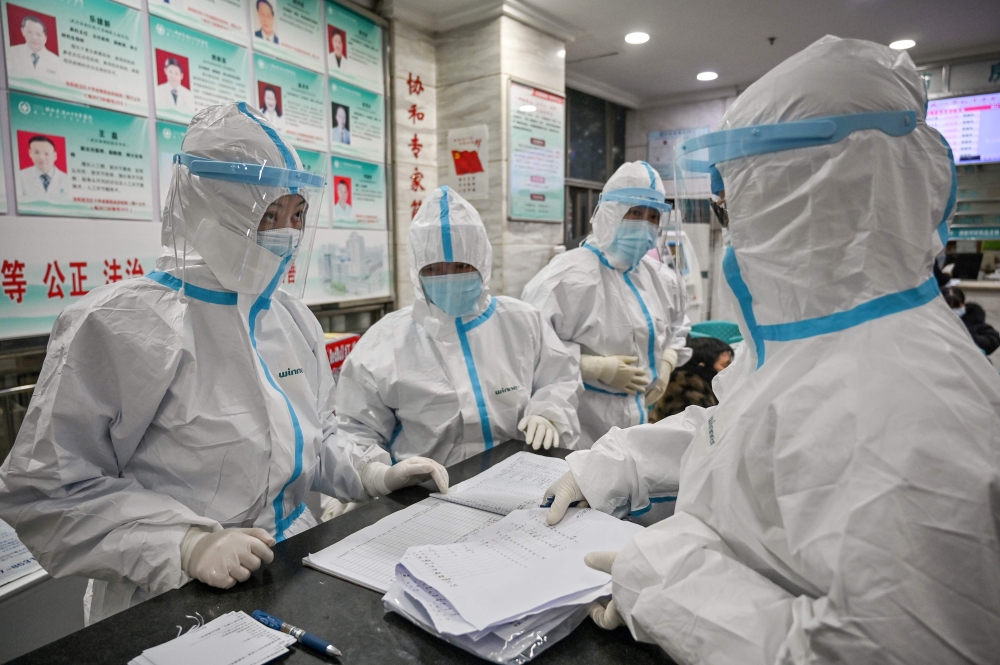  This file photo taken on January 25, 2020 shows medical staff members wearing protective clothing to help stop the spread of a deadly virus which began in the city as they work at the Wuhan Red Cross Hospital in Wuhan