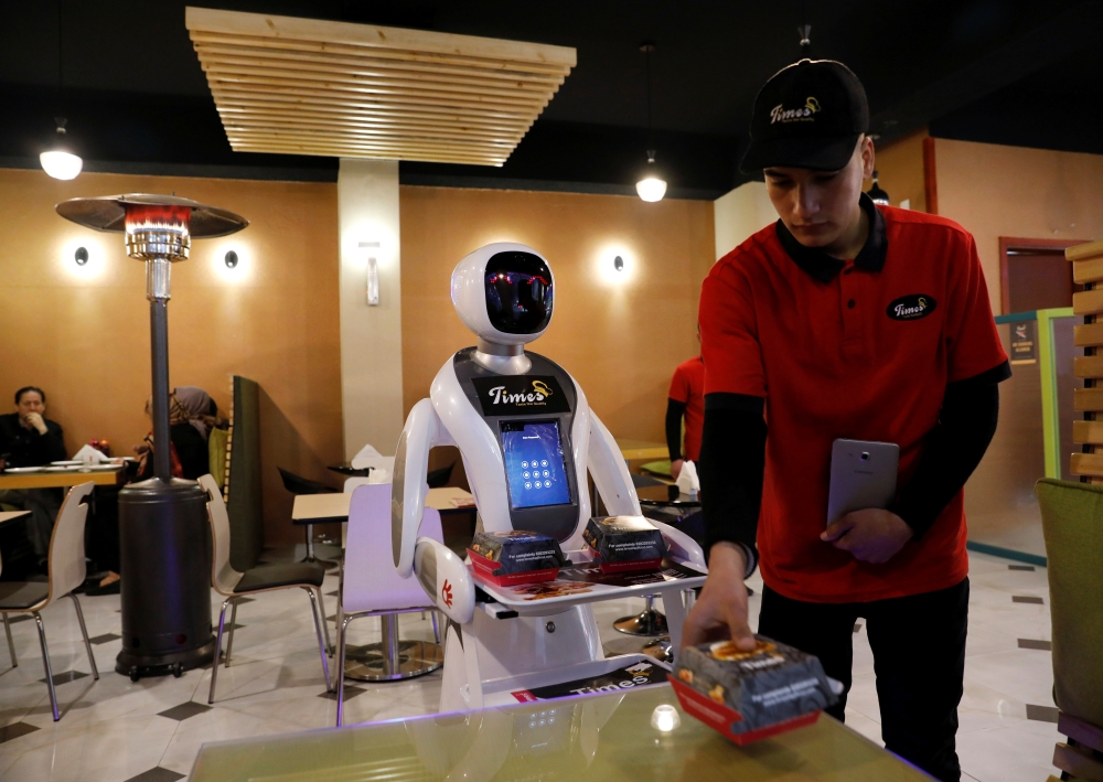 A waitress robot (Timea) delivers food to a table at the Times Fast Food restaurant in Kabul, Afghanistan February 11, 2020.REUTERS/Mohammad Ismail