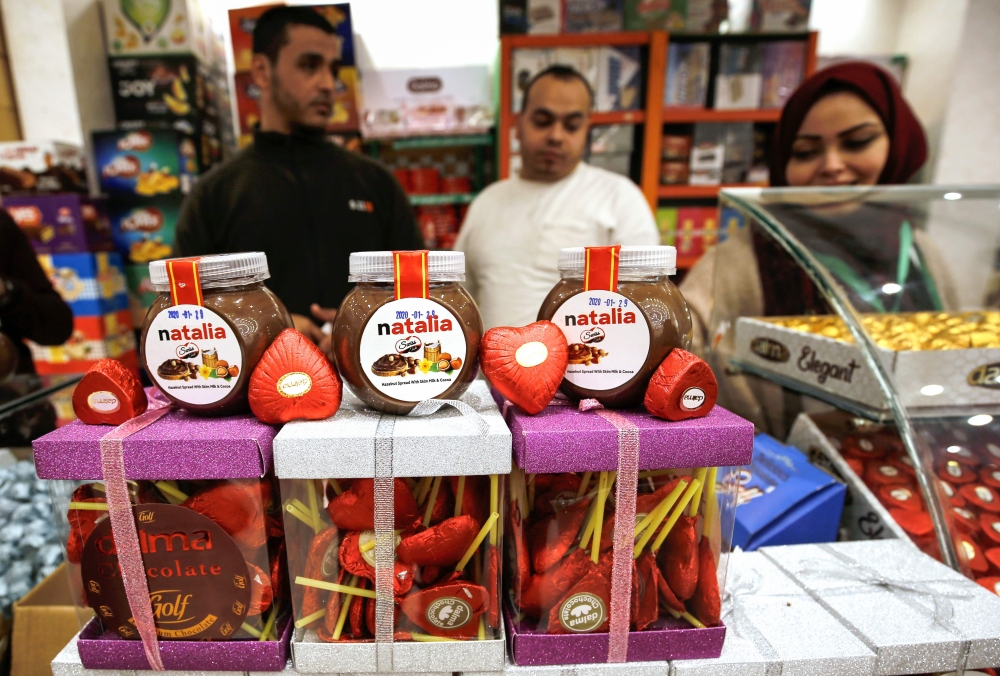 Chocolate products, including jars of a Gazan version of a world-famous spread, dubbed 'Natalia' are displayed on a shop counter in Gaza city on February 12, 2020. AFP / Mohammed Abed 