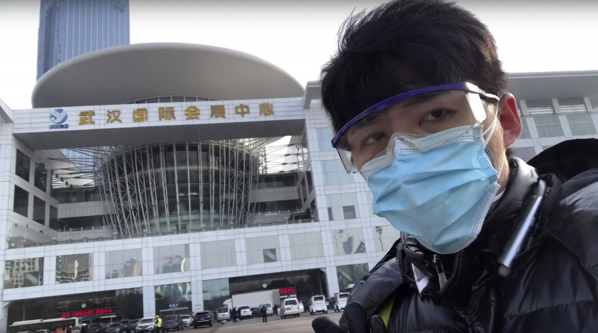 In this image from video taken Feb. 4, 2020 and released by Chen Qiushi, Chinese citizen journalist Chen Qiushi speaks in front of a convention center-turned makeshift hospital amid a viral epidemic in Wuhan in central China's Hubei province.  (Courtesy o