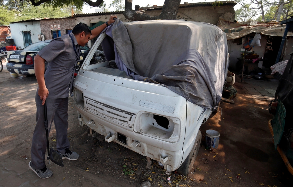 A member of bomb disposal squad from Gujarat Police scans a vehicle parked along a route that US President Donald Trump and India's Prime Minister Narendra Modi will be taking during Trump's visit later this month, in Ahmedabad, India, February 13, 2020. 