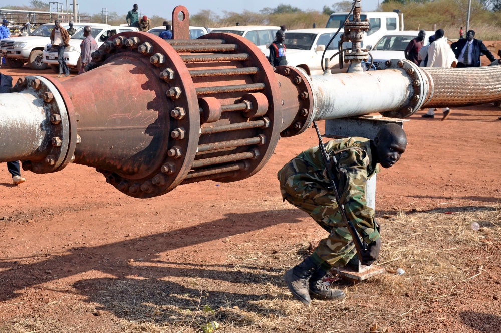 An armed member of the South Sudanese security forces is seen during a ceremony marking the restarting of crude oil pumping at the Unity oilfields in South Sudan, January 21, 2019. Reuters / Samir Bol