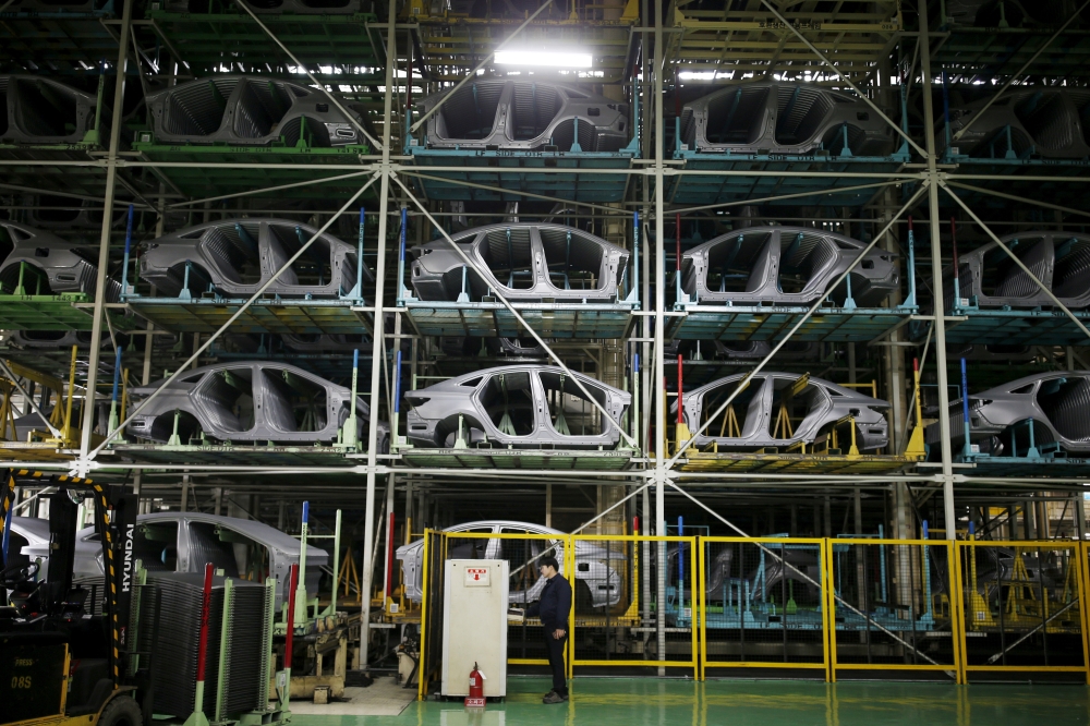 A worker stands in front of parts of Hyundai Motor's sedans at its plant in Asan, South Korea, January 27, 2016. Reuters/Kim Hong-Ji