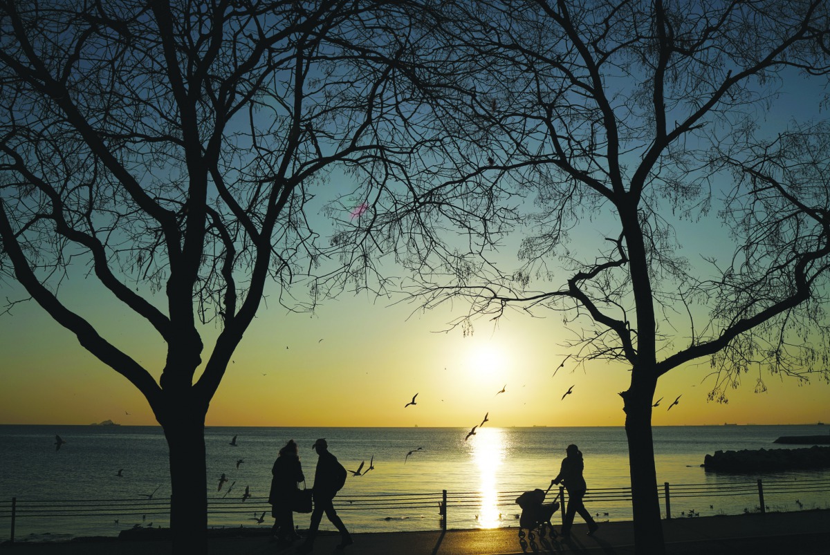 People walk along a park during the sunset in Istanbul, Turkey, February 17, 2019. Reuters/Umit Bektas
