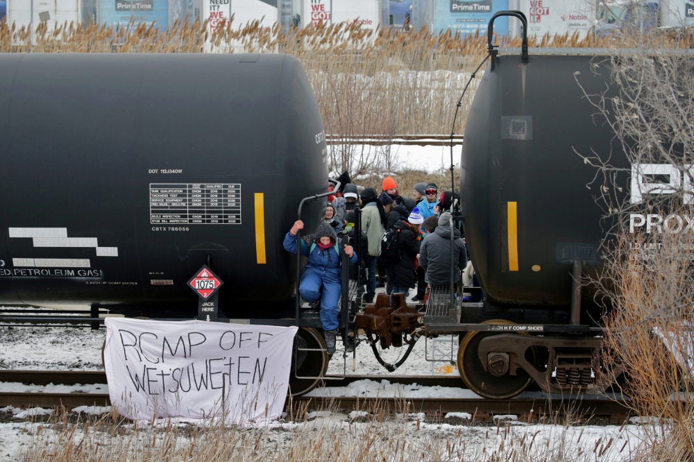 Supporters of the indigenous Wet'suwet'en Nation occupy railway tracks as part of a protest against British Columbia's Coastal GasLink pipeline, in Toronto, Ontario, Canada February 15, 2020. Reuters/Chris Helgren 