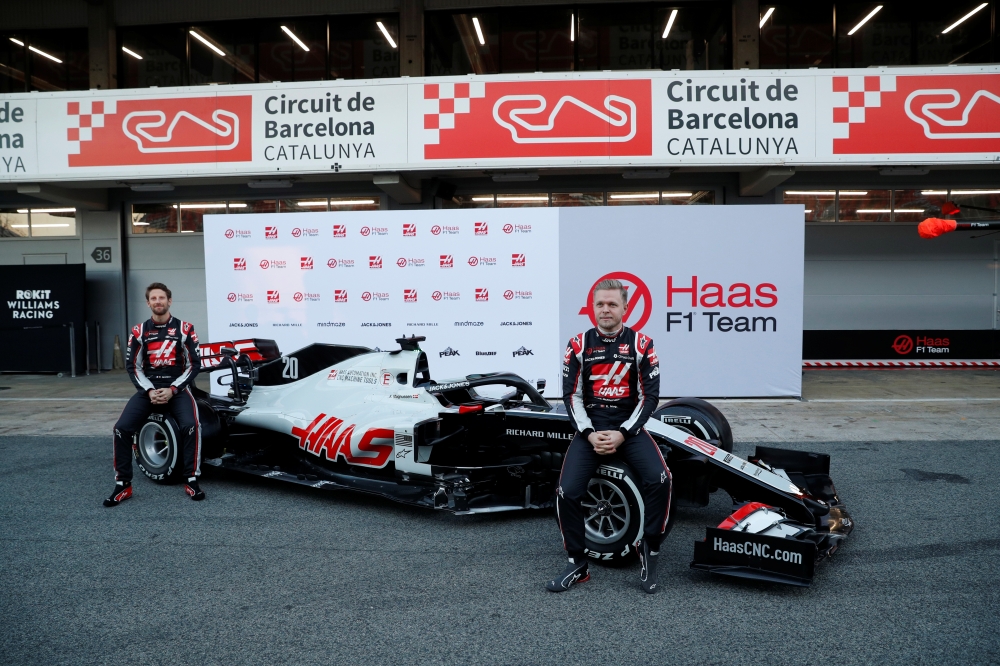 Formula One F1 - Pre Season Testing - Circuit de Barcelona-Catalunya, Barcelona, Spain - February 19, 2020 Haas' Kevin Magnussen and Romain Grosjean pose with the new car REUTERS/Albert Gea