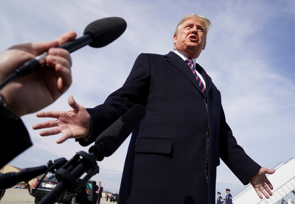 U.S. President Donald Trump talks to reporters prior to boarding Air Force One as he departs Washington for campaign travel to California from Joint Base Andrews in Maryland, U.S., February 18, 2020. REUTERS/Kevin Lamarque