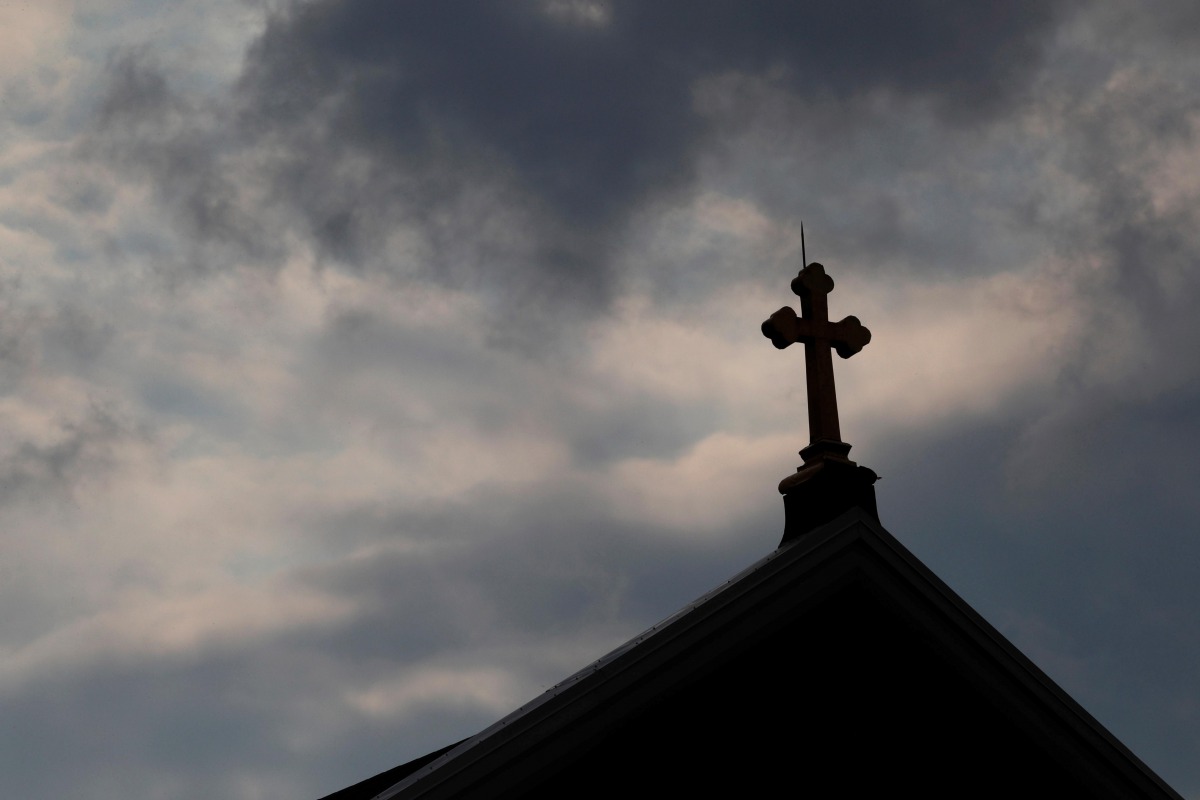 Storm clouds pass over a Roman Catholic church in Pittsburgh, Pennsylvania, US, August 14, 2018. Reuters / Jason Cohn
