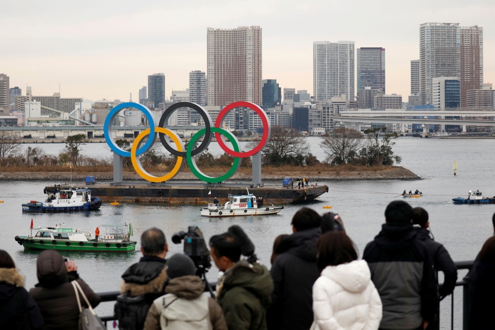 Giant Olympic Rings are installed at the waterfront area, with the Rainbow Bridge in the background, ahead of an official inauguration ceremony, six months before the opening of the Tokyo 2020 Summer Olympic Games, at Odaiba Marine Park in Tokyo, Japan Ja