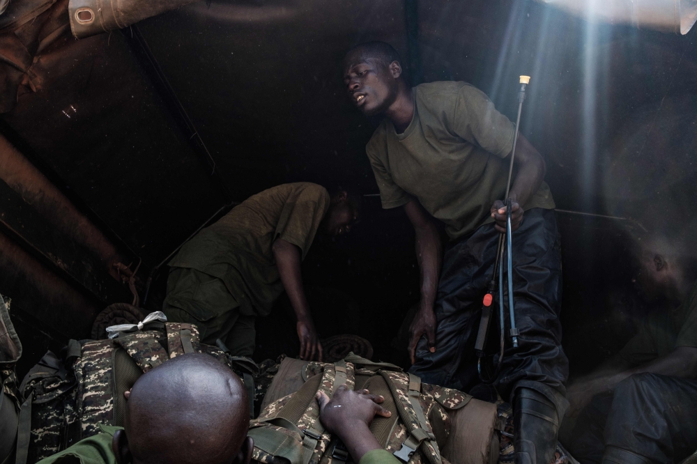 A soldier of the Uganda People’s Defence Forces (UPDF) gestures after spraying locust swarms with insecticides, with the hopes of killing the locusts, in Otuke on February 17, 2020. AFP / Sumy Sadurni
 
 