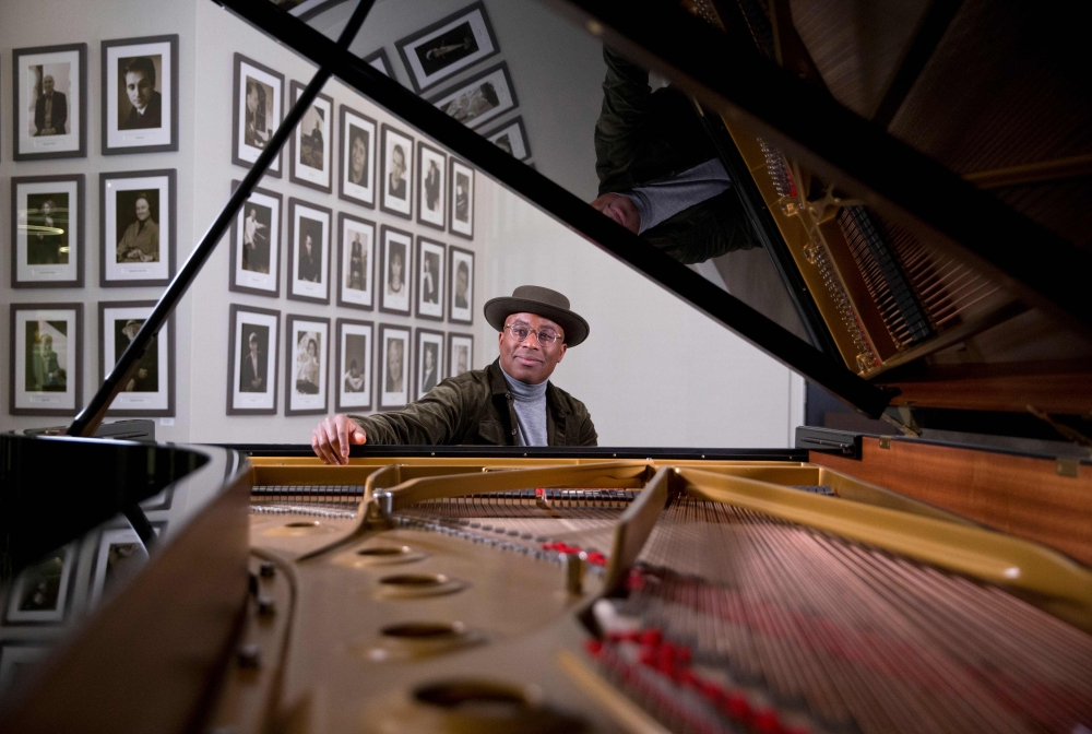 British pianist and composer Alexis Ffrench poses for a photograph after giving an interview at Steinway & Sons in London on February 19, 2020. AFP / Isabel Infantes 