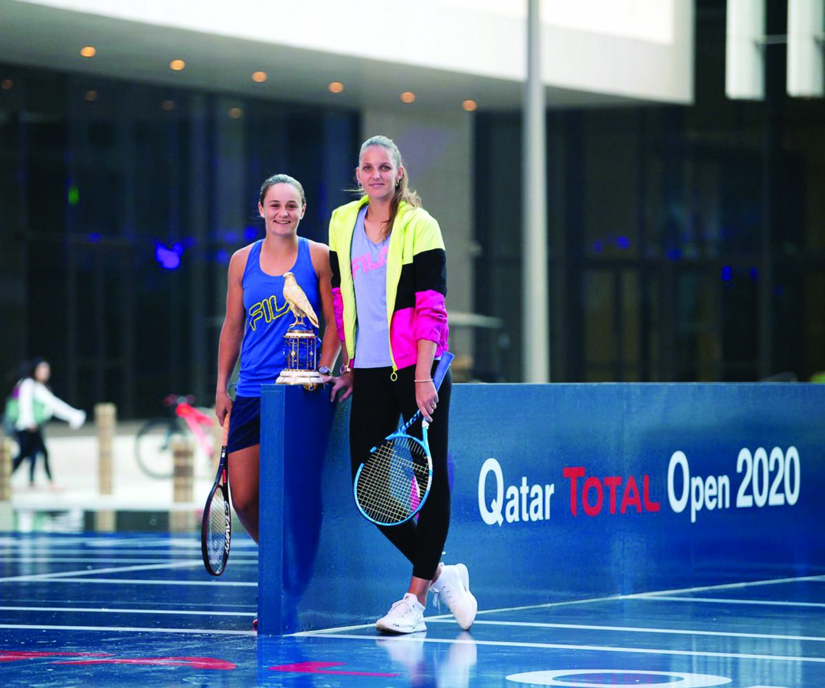 Ashleigh Barty (left) and Karolína Plískova  posing for photographs following a friendly match played at Msheireb Downtown Doha.