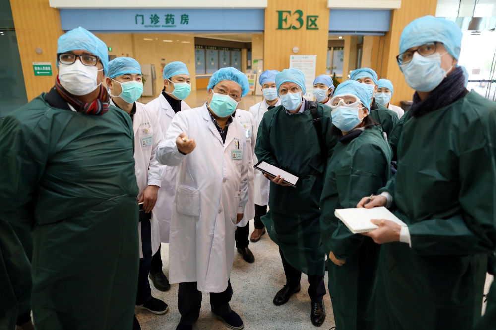 Experts from China and the World Health Organization (WHO) joint team wearing face masks visit the Wuhan Tongji Hospital in Wuhan, the epicentre of the novel coronavirus outbreak, in Hubei province, China February 23, 2020. China Daily via REUTERS 