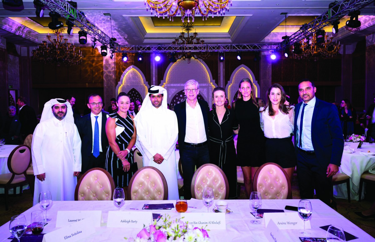 The players taking part in the Qatar Total Open pose for a picture with Qatar Tennis Federation President Nasser bin Ghanim Al Khelaifi, former Arsenal Manager Arsene Wenger and Tournament Director Karim Alami during the gala dinner in Doha on Sunday.