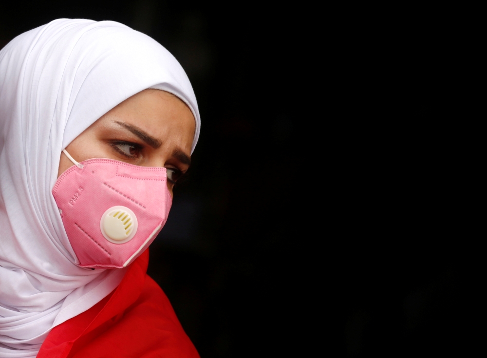 A demonstrator wears protective face mask, following the outbreak of the new coronavirus during ongoing anti-government protests in Baghdad, Iraq February 25, 2020. Reuters/Wissm al-Okili 
 