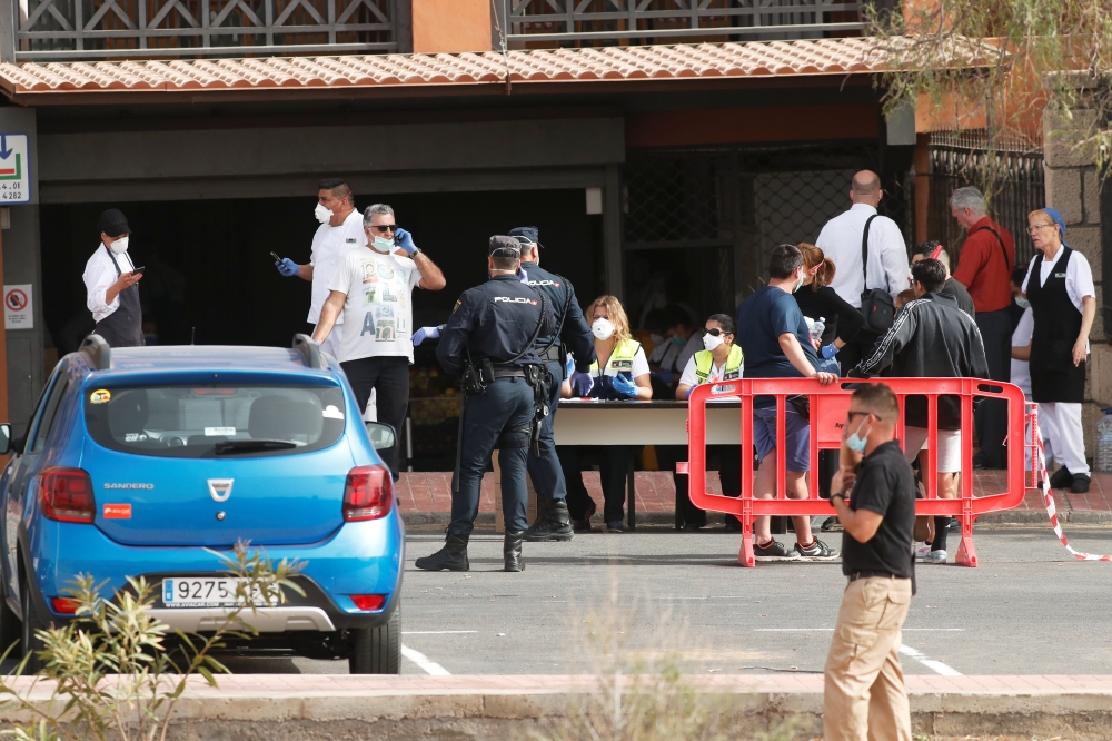 Emergency workers rest at a health control outside of H10 Hotel, which is on lockdown after novel coronavirus has been confirmed in Adeje, on the Spanish island of Tenerife, Spain February 25, 2020. Reuters/Borja Suarez