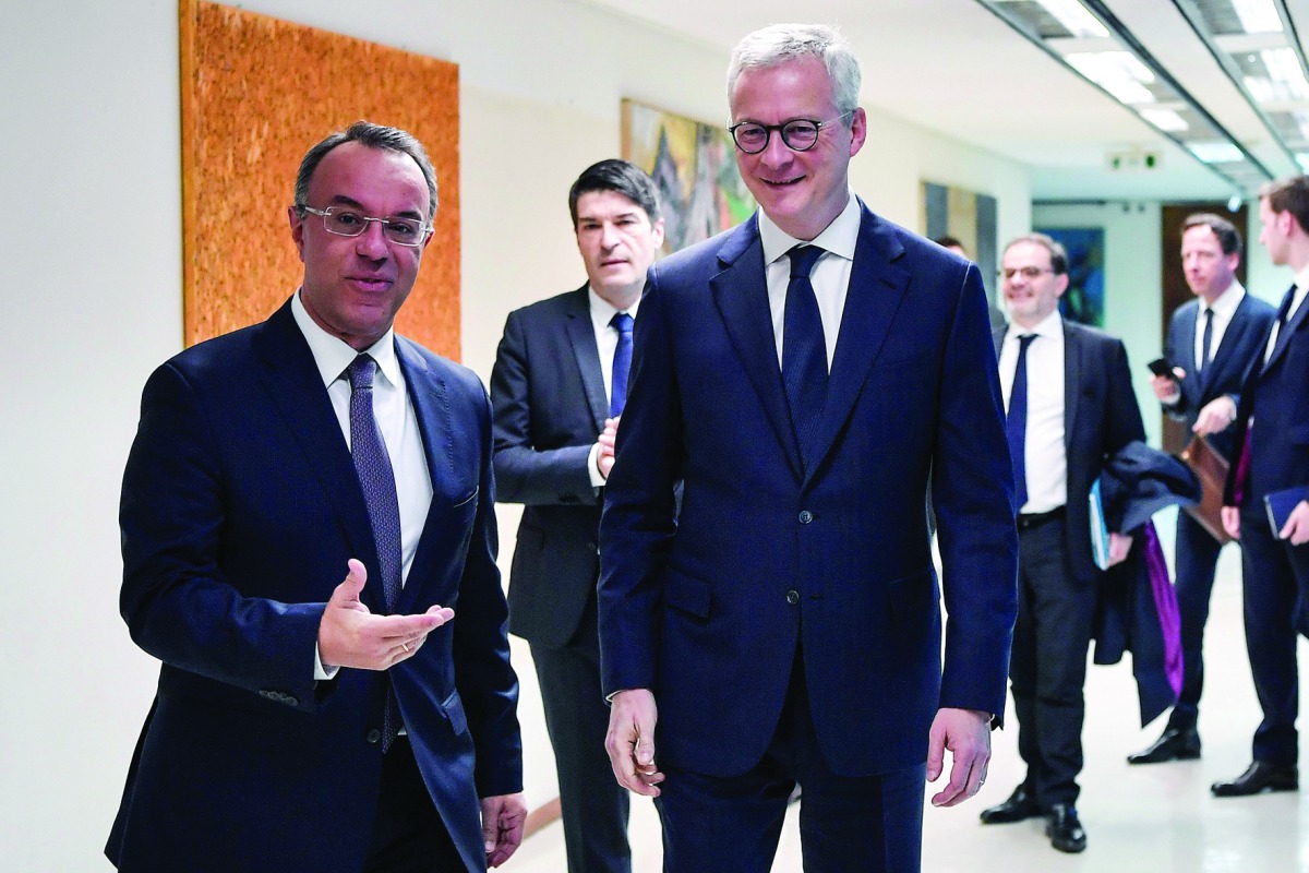 Greek Finance Minister Christos Staikouras (L) welcomes his French counterpart Bruno Le Maire prior to their talks in Athens on February 25, 2020. AFP / Louisa Gouliamaki