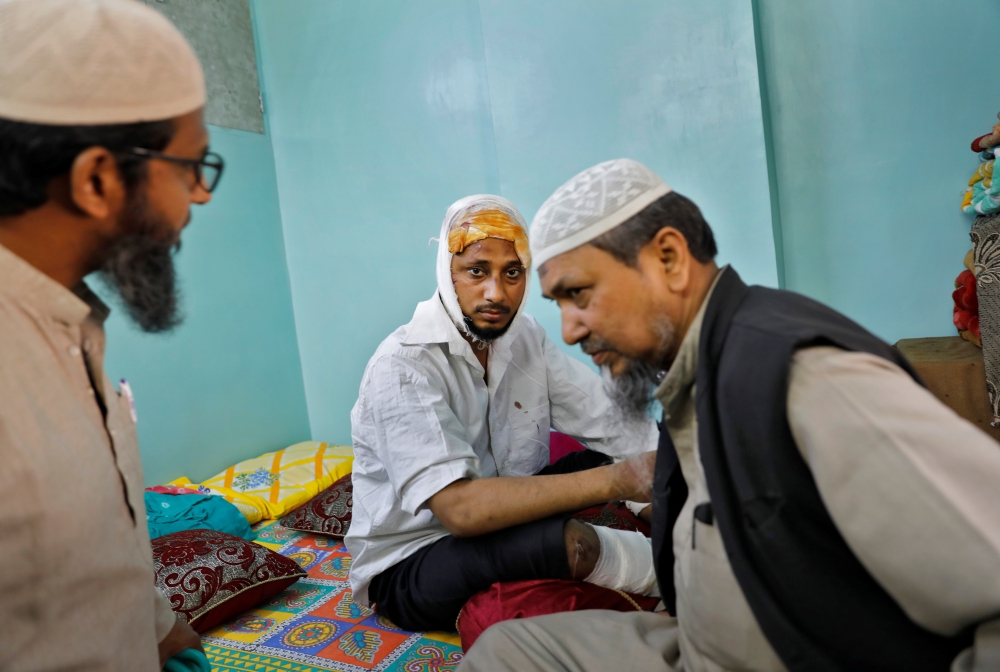 Mohammad Zubair, 37, who is Muslim and was injured after being beaten by a group of men chanting pro-Hindu slogans during protests sparked by a new citizenship law, sits inside his relative's house in New Delhi, India, February 26, 2020.  Reuters/Danish S