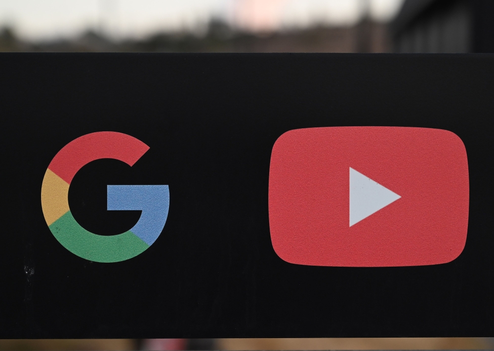 In this file photo taken on November 21, 2019, the Google and YouTube logos are seen at the entrance to the Google offices in Los Angeles, California. AFP / Robyn Beck